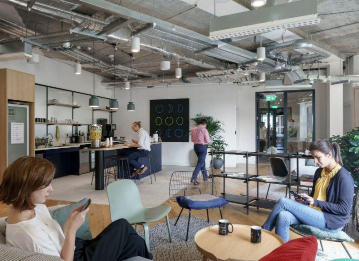 The scene inside the Iveagh Court WeWork building in Dublin with people sitting around using their smartphones.