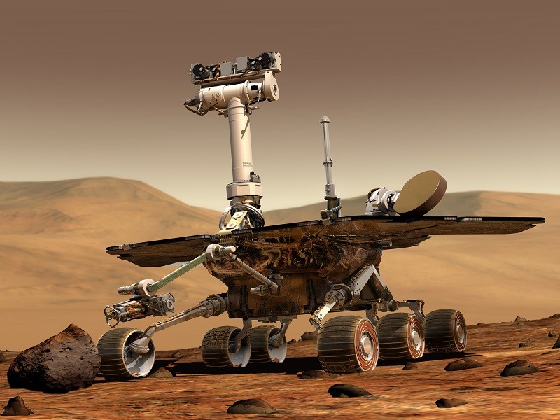 3D render of rover machine with wheels and cameras in desert-like brown surroundings of Mars.