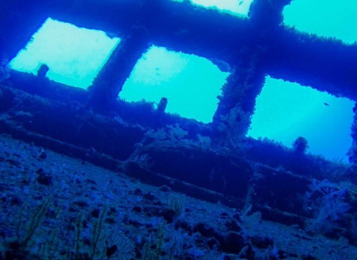 Squares cut out of a shipwreck submerged in the ocean.