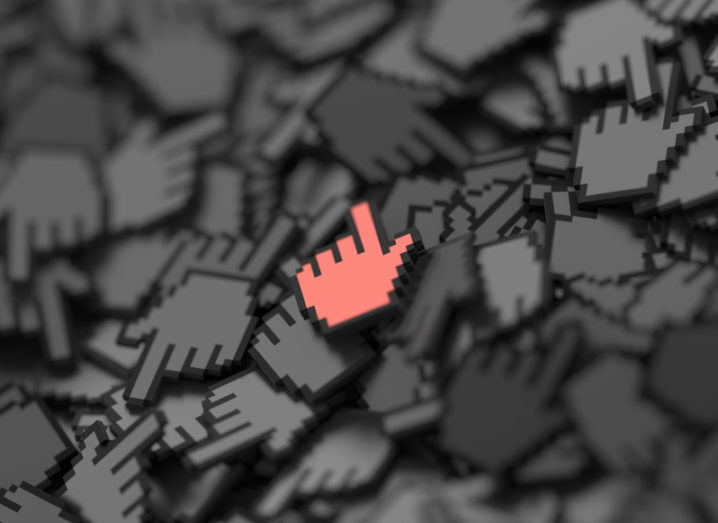 A 3D rendering of the hand icon that appears when you hover a mouse over an internet link. One red highlighted hand in a pile of dark grey ones.