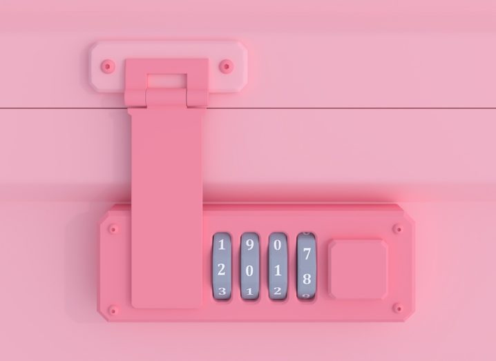Pink combination code lock on a suitcase, representing privacy.