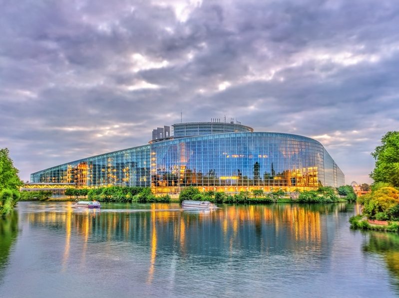 The Louise Weiss building of European Parliament in Strasbourg, France at sunset on the waterfront.