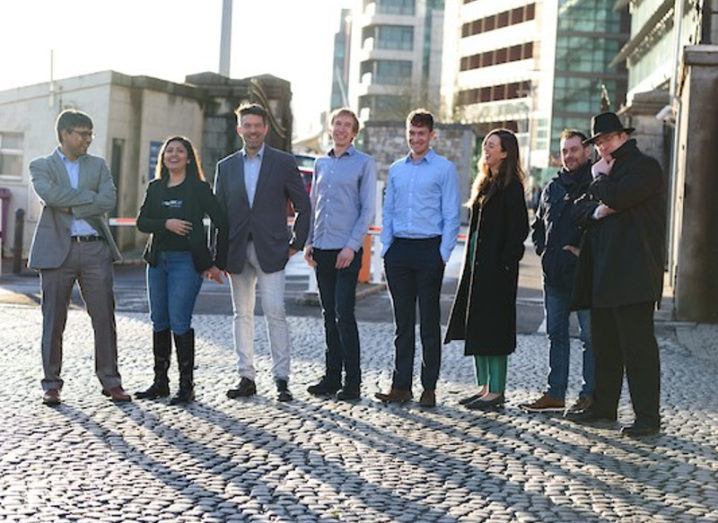 Group of young entrepreneurs standing on a sun-drenched Cork harbour.