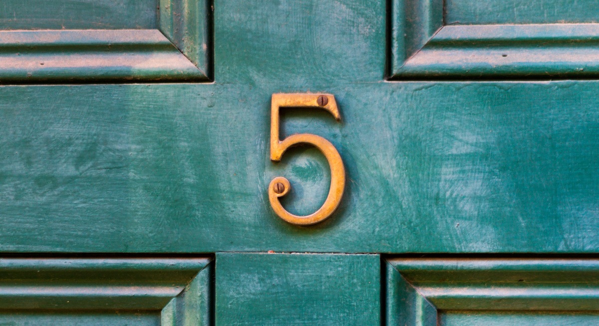 A gold number five on a dark green door representing the number of reasons Inspirefest will help grow your career.