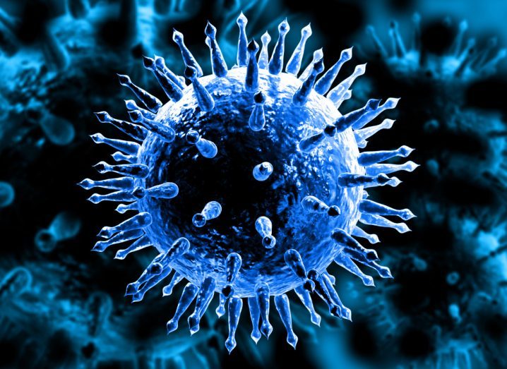 A microscopic view of the influenza virus in a blue hue.