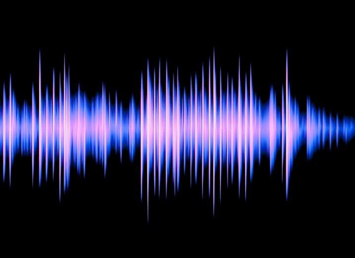 A black background with a blue-purple sound wave passing through the middle.