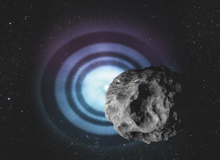 Illustration of an asteroid passing in front of a star emitting waves of light.