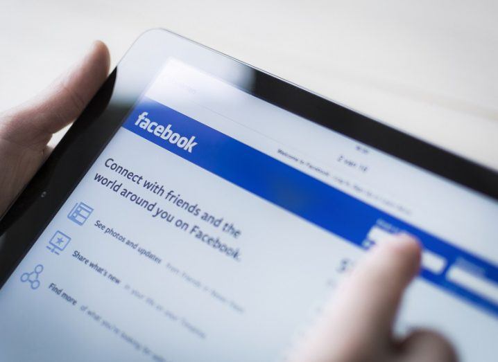 Close-up of a tablet being used by someone to log in to Facebook.