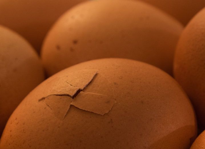 Picture of eggs with one with a crack in it.