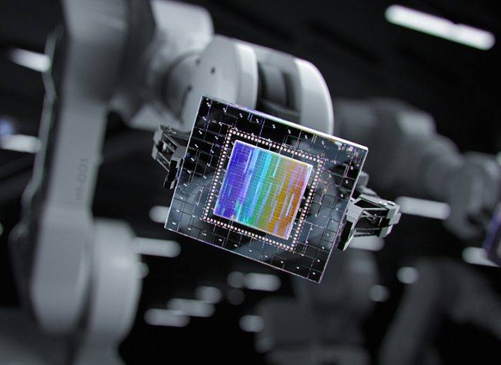 Close-up shot of robotic arm holding new-generation futuristic processor.