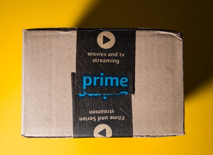 View looking directly down on an Amazon Prime delivery box sitting on a yellow background.