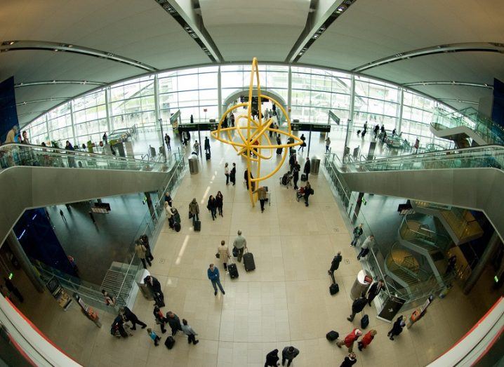 Fisheye camera shot of passengers in the main lobby area of Terminal 2 at Dublin Airport.
