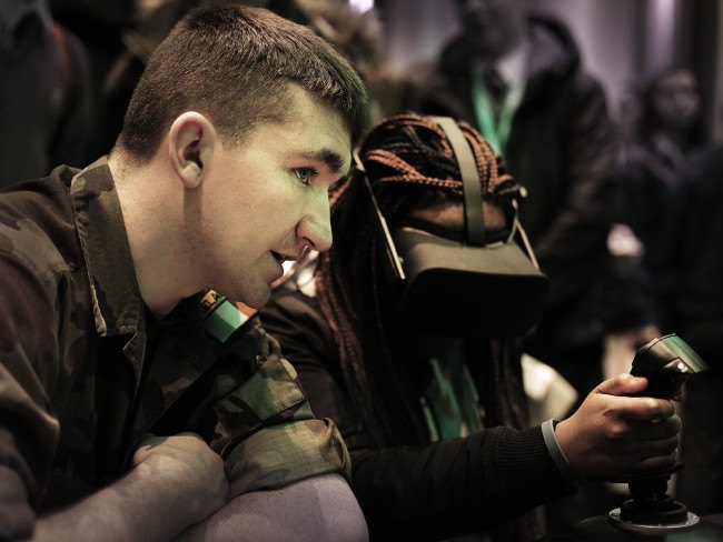 Soldier at a recruitment fair showing virtual reality in action.