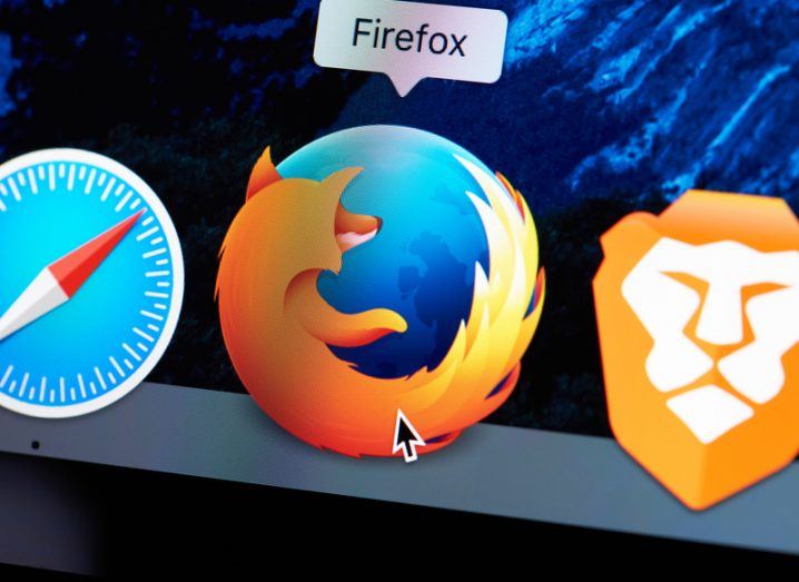Mouse cursor hovering over the Firefox browser icon on a Mac desktop.