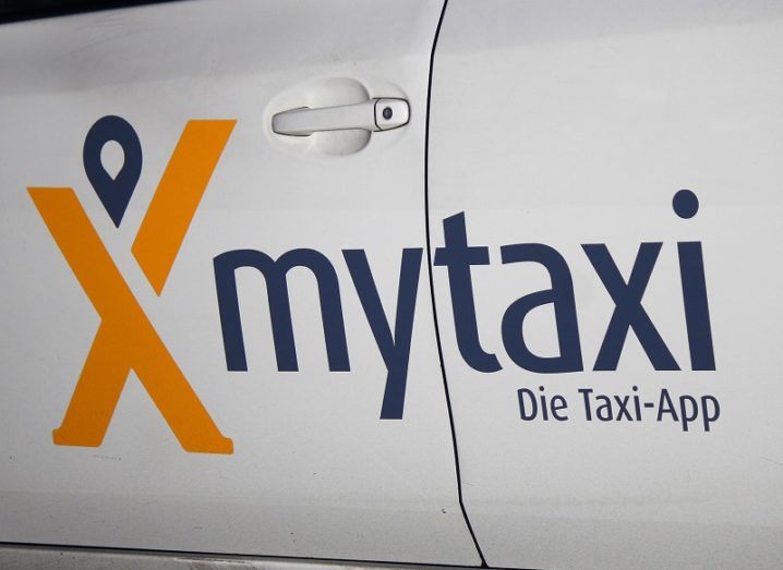 Close-up of the Mytaxi logo on the side of a white car door.