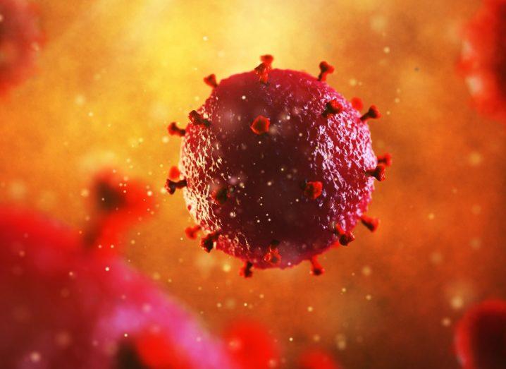 3D illustration of HIV coloured red against a hazy, yellow background.