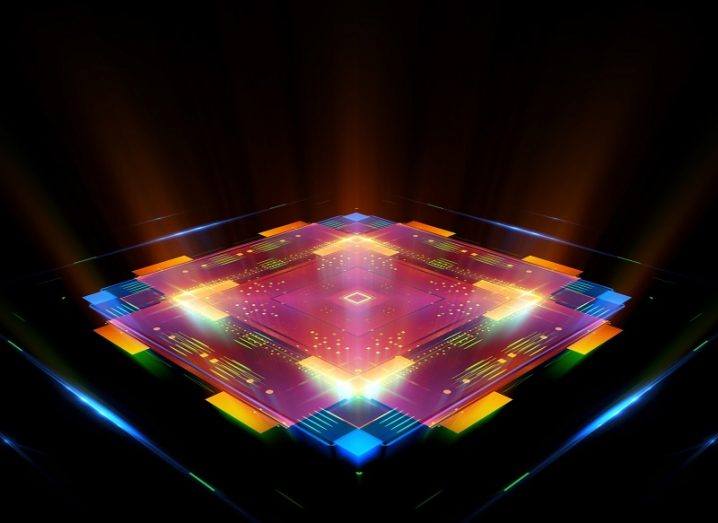 3D illustration of a super-fast quantum computer chip coloured pink, blue and yellow against a black background.