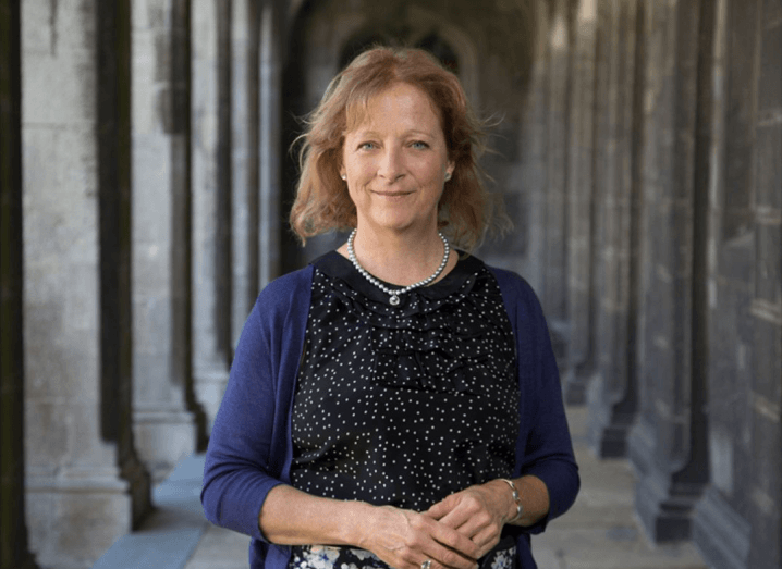 Dr Una Fitzgerald standing outside NUI Galway with her hands resting in front of her.