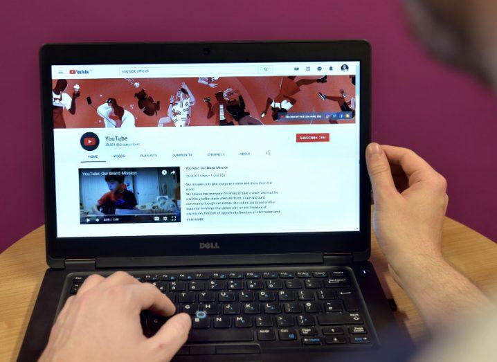 Over-the-shoulder view of a laptop user visiting YouTube’s channel on the YouTube website.