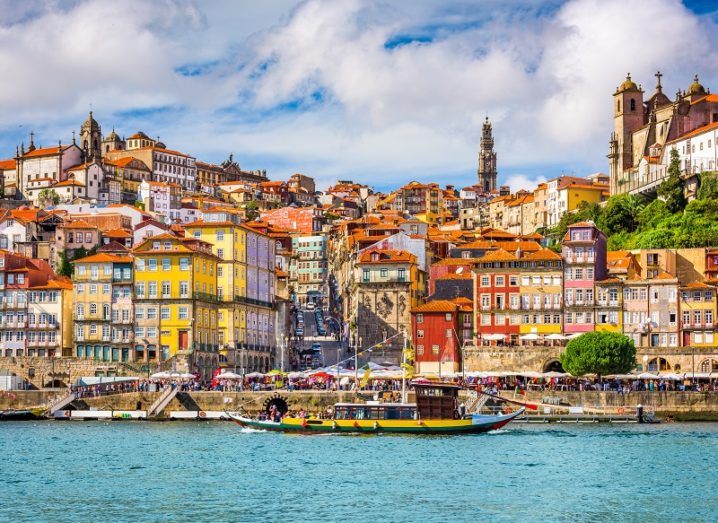 Porto old town skyline from across the Douro River with multi-coloured buildings.