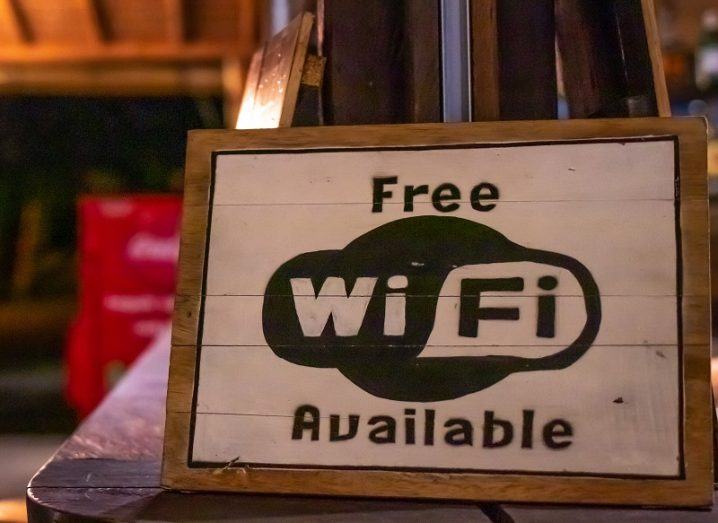 Free Wi-Fi sign on a wooden board outside a cafe.