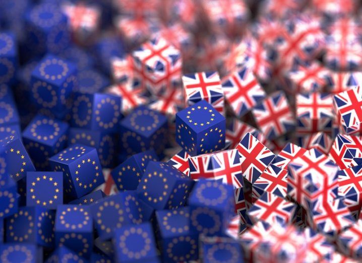 3D render of cubes covered in EU flags and UK flags colliding.