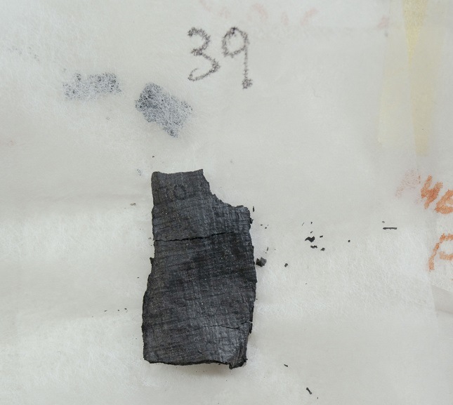 One of four fragments from the Herculaneum scrolls on a white background.