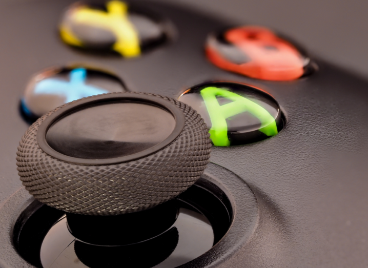 A macro shot of the A, B, X and Y buttons on a black Xbox One controller.