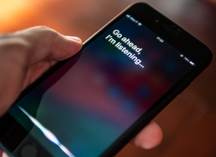 View of smartphone with Siri voice assistant displayed.