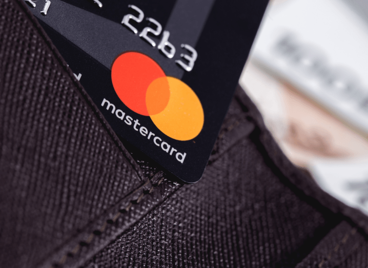 The Mastercard logo displayed on a credit card in a wallet.