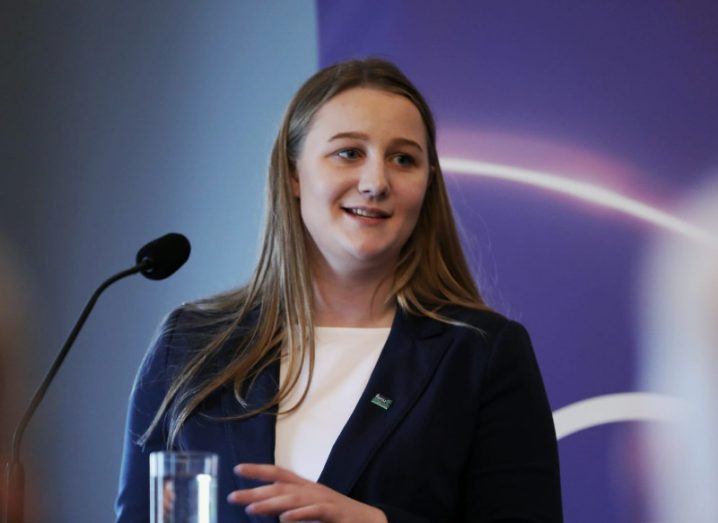 A young woman speaking at a podium.