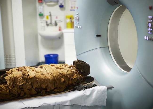 The mummy being put into a CT scanner. 