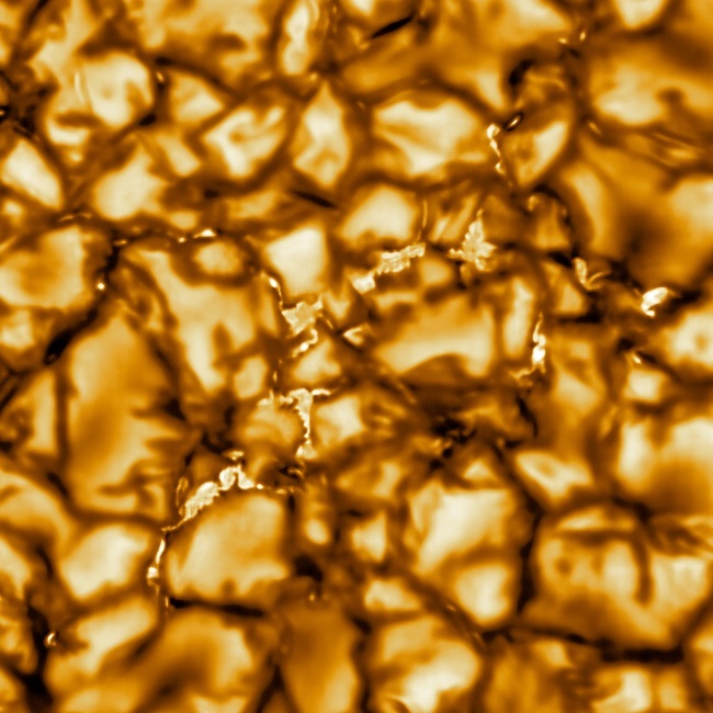 Close-up of the sun with cell-like structures coloured yellow and black.