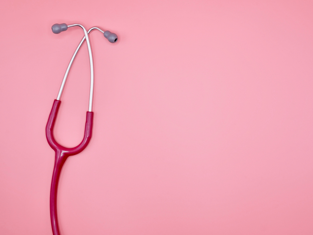 A red stethoscope on a pink background.
