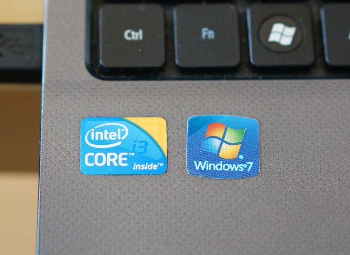 Close-up of the Windows 7 and Intel Core stickers on a slate-grey laptop.