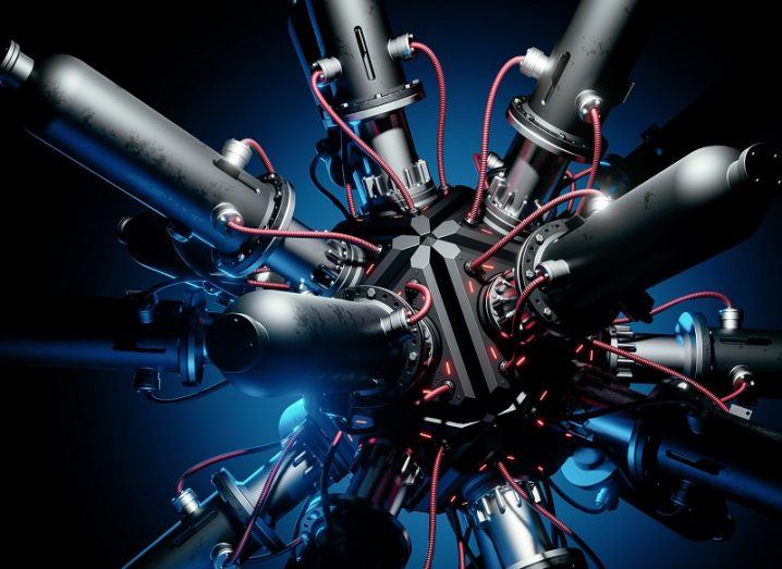 Series of pipes connected to a central ball covered in wires against a black and blue background.