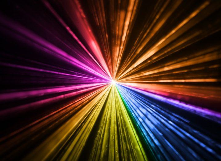 Multicoloured laser light against a black background.