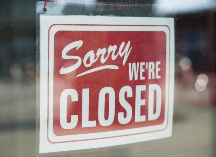 A red sign that says 'Sorry, we're closed' in the glass window.