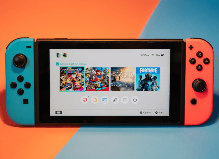 The Nintendo Switch console with the screen lit up showing the device's home screen.