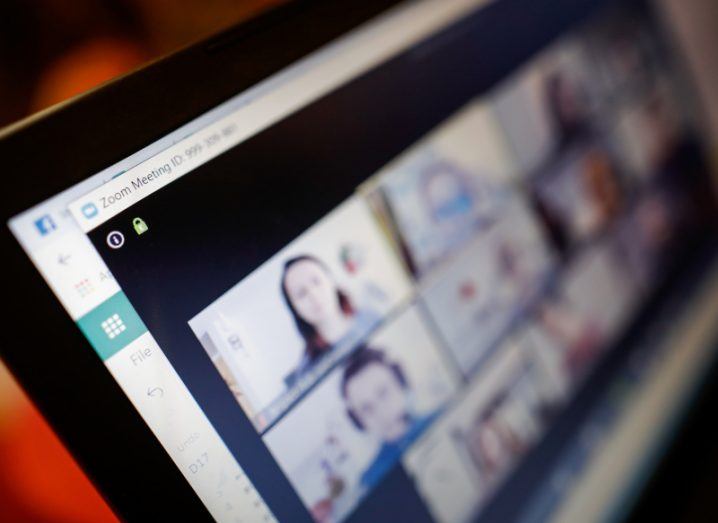 A Zoom meeting on a computer screen, with blurry images of participants appearing across the screen.