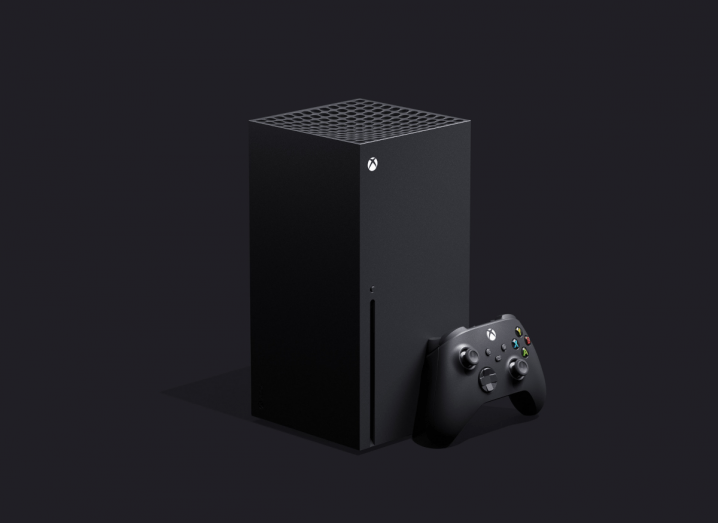 The black Xbox Series X console in front of a slate grey background.