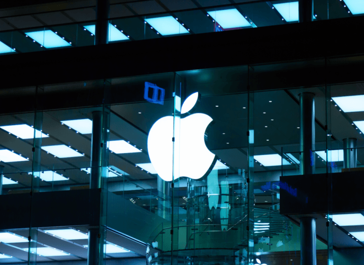 The Apple logo displayed on the front of a glass building.
