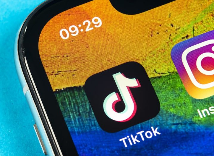 The TikTok app on a smartphone screen with a multicoloured background.