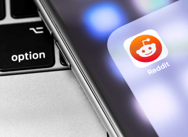 The Reddit logo displayed on an iPhone screen.