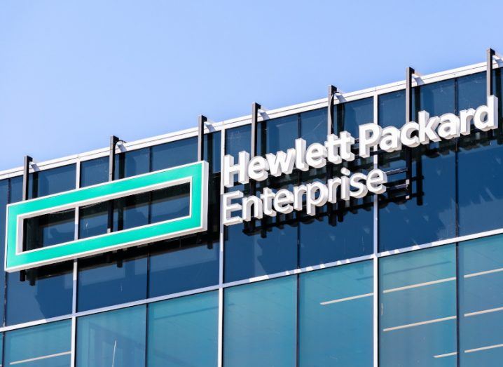 Hewlett Packard Enterprise logo on the side of a building against a blue sky.