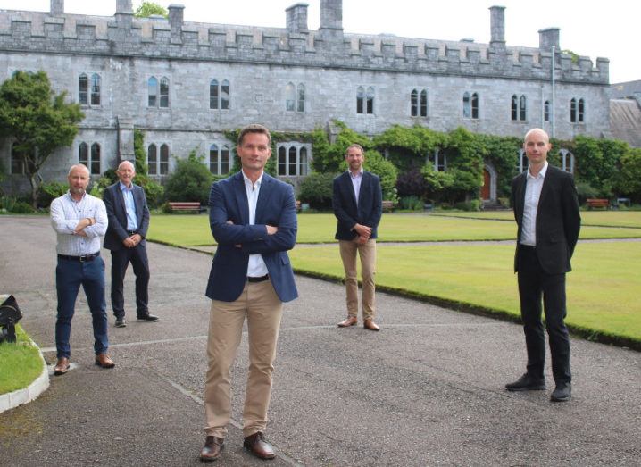 A group of researchers from SeqBiome are standing in the grounds of University College Cork and smiling into the camera.