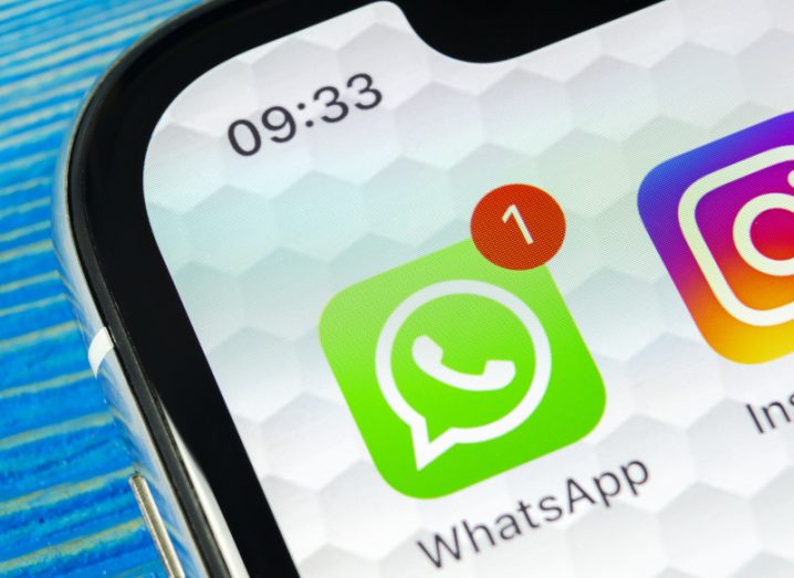 A close-up of the WhatsApp app icon on a smartphone screen, with a notification indicating that a message has been received.
