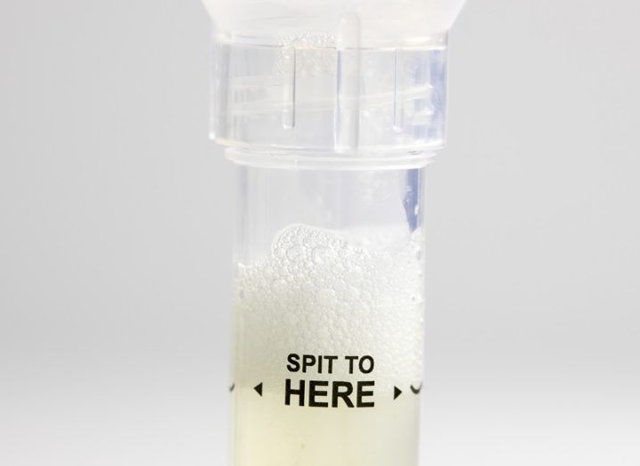 Test tube with the words 'spit to here' written on it and containing spit.