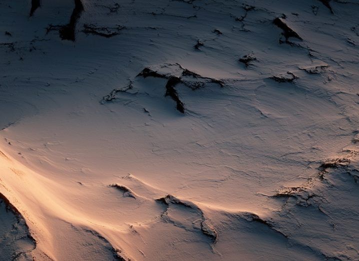 Desolate Antarctic wilderness at dusk seen from the air.