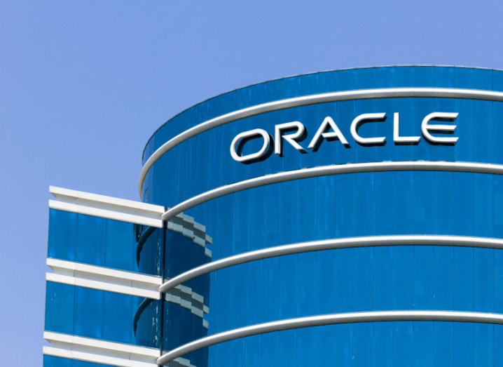 The Oracle logo on the side of a large, glass office building.